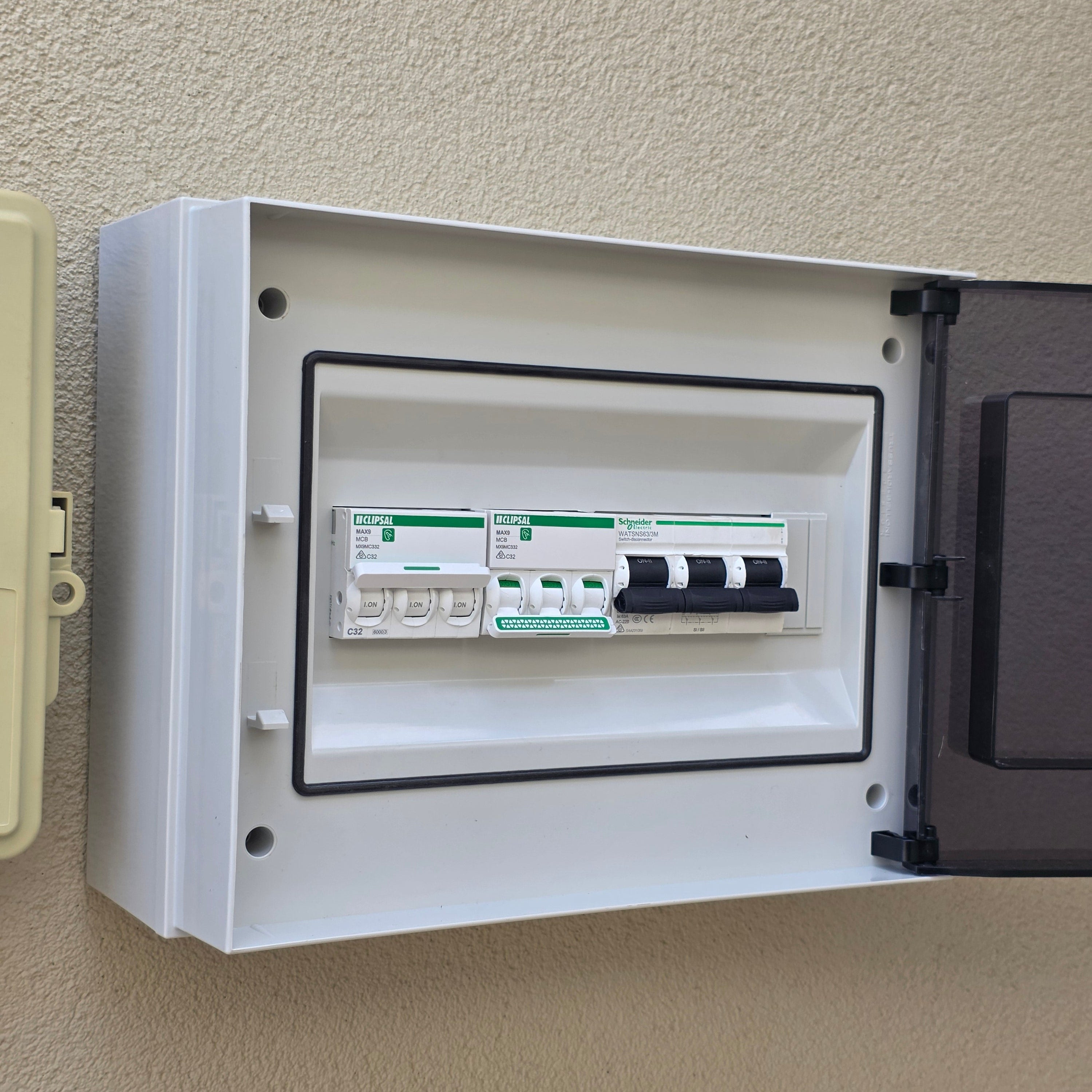 Electrical panel with a cover open on a beige wall